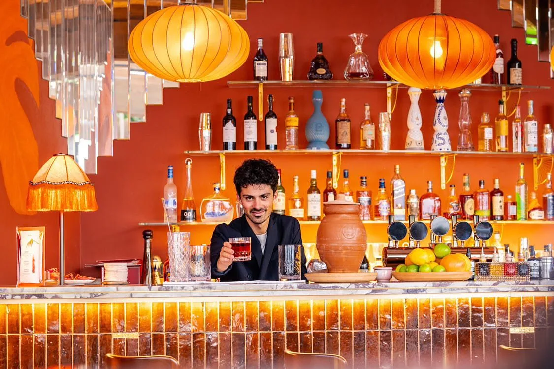 Marco Stella, bartender, behind a bar